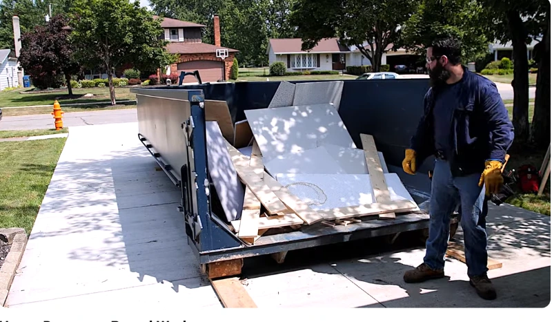 Homeowners loading a residential dumpster rental during a New Braunfels cleanout