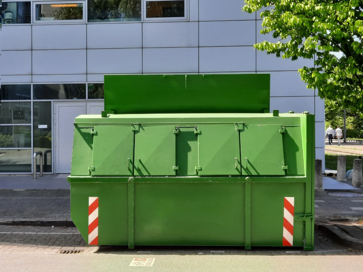 Residential roll-off dumpster placed curbside for a home cleanout in New Braunfels, TX